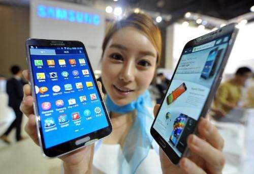 A model holds Samsung's first curved smartphone, the Galaxy Round, at the Electronics and IT Industry Fair in Goyang, north of S