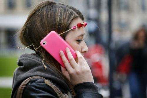 A woman uses her smartphone in Bordeaux, France on May 3, 2013