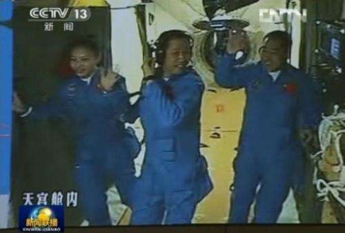 Chinese astronauts (L-R) Wang Yaping, Nie Haisheng and Zhang Xiaoguang in a CCTV frame grab, June 13, 2013