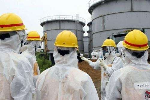 Japan's nuclear watchdog members inspect contaminated water tanks at the Fukushima nuclear power plant, August 23, 2013