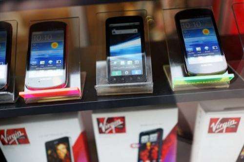 Mobile phones sit on display in the window of a store on January 14, 2013 in New York City