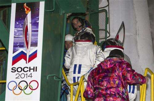 Olympic torch blasts into space for 1st spacewalk