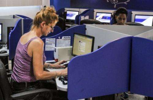 People use the internet at a cybercafe in Havana on June 21, 2013