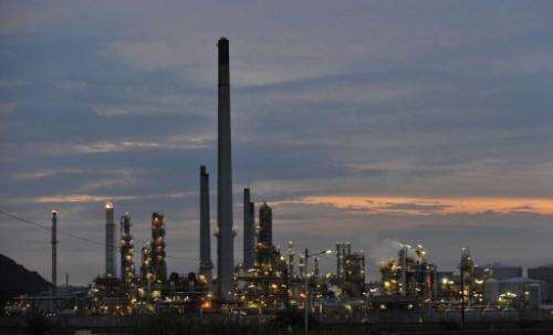 Smoke billows from a refinery just outside Durban City on November 29, 2011