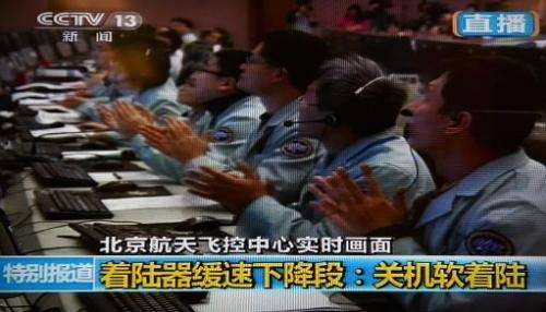 This screen grab taken from CCTV live broadcasting footage shows scientists celebrating at the control centre in Beijing after C
