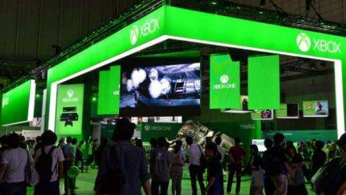 Visitors walk past Microsoft's Xbox One stall at the Tokyo Game Show in Chiba, suburban Tokyo on September 19, 2013