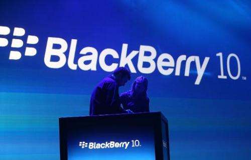 Workers prepare the podium before the start of the BlackBerry 10 launch event by Research in Motion at Pier 36 in Manhattan on J