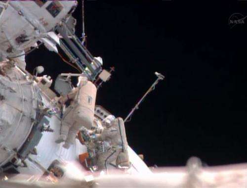 2 Russians take spacewalk outside space station