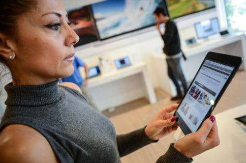 Customers look at the iPad mini at an Apple store in Rome on November 2, 2012