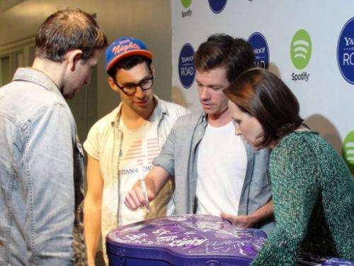 Members of the Grammy-winning band fun. sign a Yahoo music road tour guitar case in San Francisco, May 31, 2013