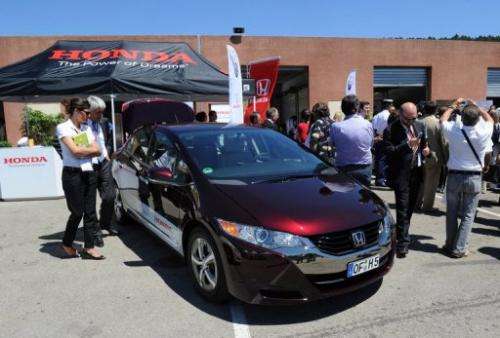 People look at a Honda's FCX Clarity hydrogen fuel-cell car, on July 7, 2010 in Ales, France