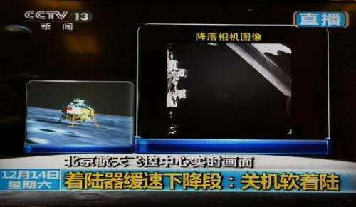 This screen grab taken from CCTV live broadcasting footage shows an image (right) of China's first lunar rover transmitted back 