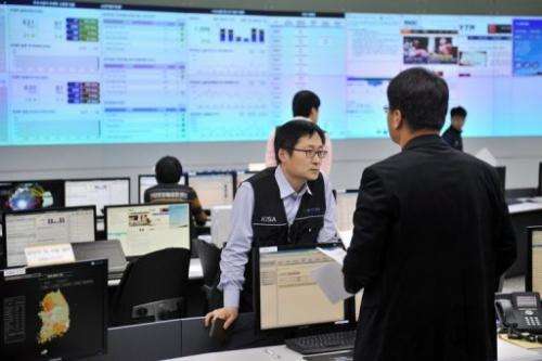 Members of the Korea Internet Security Agency are seen investigating cyber attacks, in Seoul, on March 20, 2013