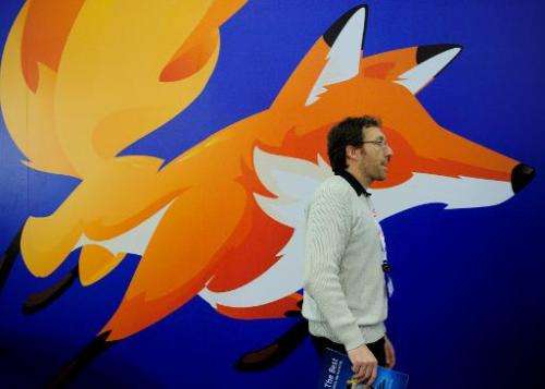A man walks past a poster of Mozilla Firefox on February 27, 2013 at the Mobile World Congress in Barcelona