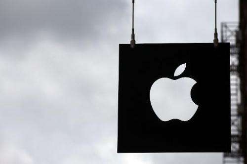 The Apple logo hangs in front of an Apple store on July 23, 2013 in New York City