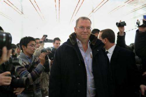 Google Executive Chairman Eric Schmidt (C) makes his way past the media at Beijing International airport January 7, 2013
