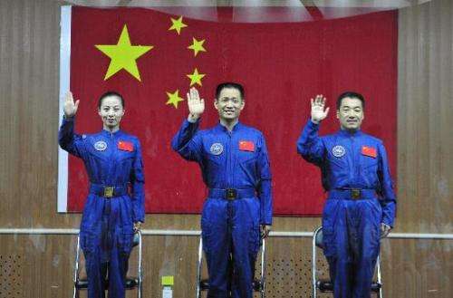 Image taken on June 10, 2013 shows crew members of Shenzhou-10 (L-R) Wang Yaping, Nie Haisheng and Zhang Xiaoguang at a press co