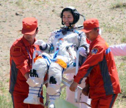 Image taken on June 29, 2012 shows China's first female astronaut Liu Yang being carried out of the Shenzhou-9 spacecraft in a r