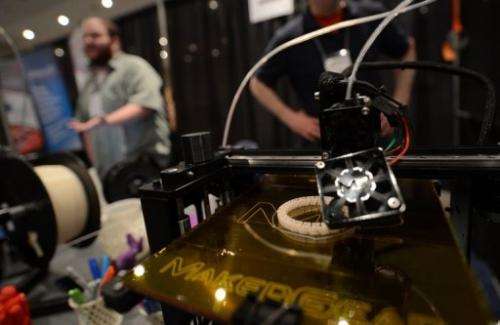 A 3D printer prints an object during an exhibition in New York on April 22, 2013