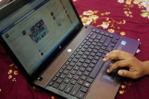 A Bangladeshi woman logs onto social networking website Facebook on her laptop in Dhaka on May 15, 2012