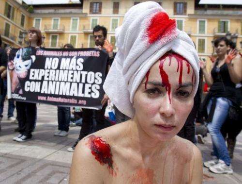 Activists hold placards reading &quot;Stop Animal testing&quot; in Palma de Mallorca, on April 29, 2011