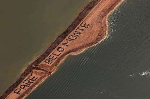 Activists occupy an earthen dam and form the sentence &quot;Stop Belo Monte&quot;, over the Xingu River in Para, northern Brazil