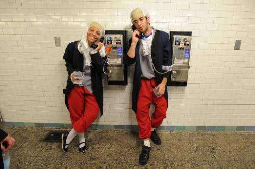 Actors dressed as Benjamin Franklin talk on pay phones on June 29, 2013 in New York City in a campaign by Virgin Mobile which en