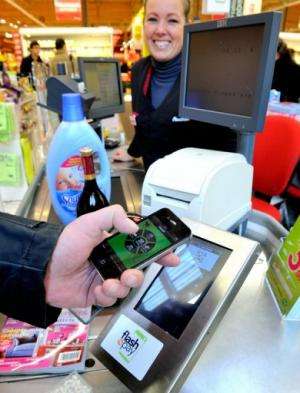 A customer pays via a smartphone application in a Auchan supermarket near Lille, northern France  on December 6, 2012
