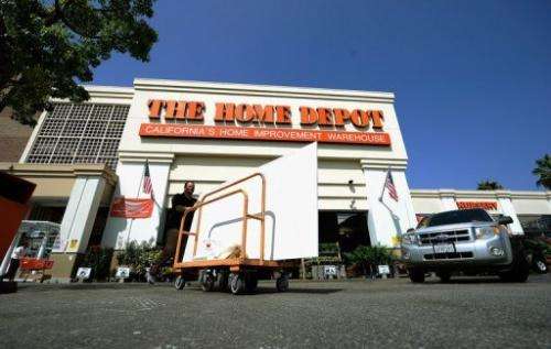 A customer pushes a cart with supplies at the Home Depot store on August 16, 2011 in the Hollywood, California