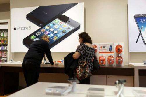 Advertisements for the iPhone 5 are displayed at an mobile phone store on January 14, 2013 in New York City