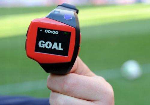 A FIFA officer displays a watch during a demonstration of goal-line technology in Tokyo on December 8, 2012