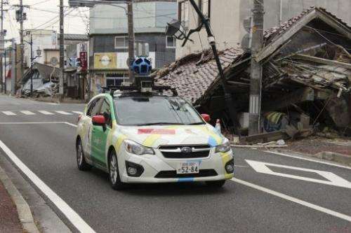 A Google car mounted with a street view camera drives through a street in Fukushima Prefecture in March 2013