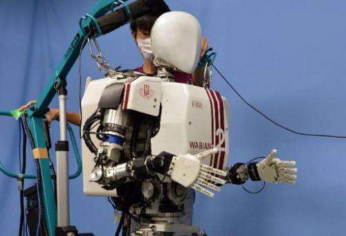 A humanoid robot &quot;Wabian-2R&quot;, developed by Japan's Waseda University professor Atsuo Takanishi walks for a demonstrati