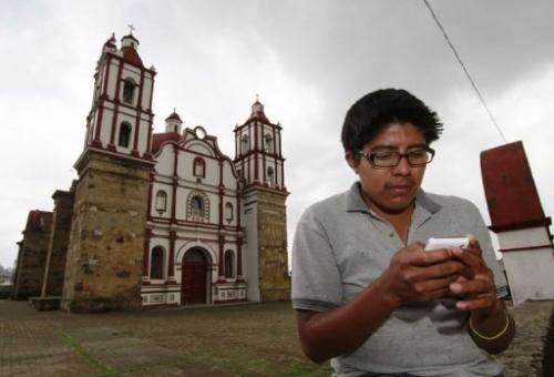 A local resident uses his mobile phone in Talea de Castro in Mexico, on August 17, 2013