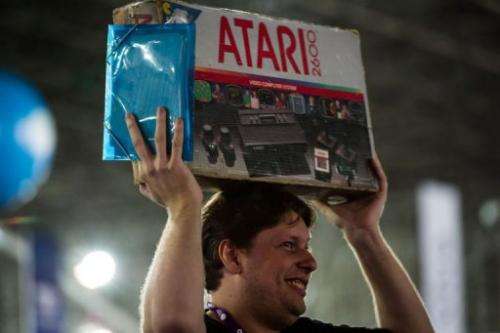 A man carries a box with an Atari game in Sao Paulo, Brazil, on January 30, 2013
