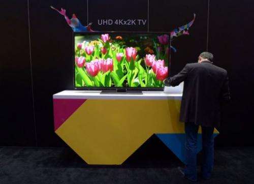 A man check out an UHD 4Kx2K TV at the TCL booth at CES on January 10, 2013 in Las Vegas, Nevada