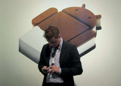 A man checks his mobile phone at the Mobile World Congress in Barcelona on February 29, 2012