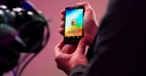A man holds a Motorola RAZRi smartphone with an Intel processor during the launch of the device on September 18, 2012