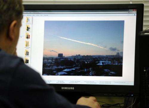 A man in Moscow looks at a computer screen on February 15, 2013, showing the trail of a meteorite