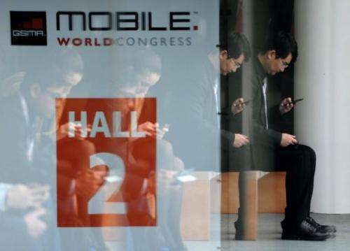 A man looks at his mobile phone during the 2013 Mobile World Congress in Barcelona on February 28, 2013