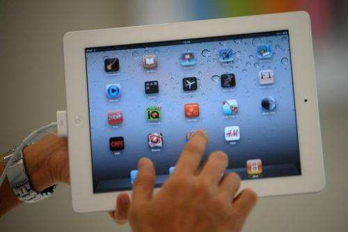 A man navigates through an iPad 2 on April 29, 2011