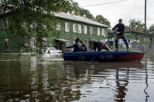 A man paddles a boat down a flooded street near Khabarovsk in Russia's Amur region, August 20, 2013