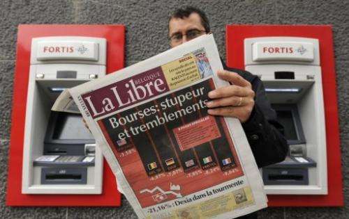 A man reads La Libre Belgique newspaper in Brussels on October 7, 2008