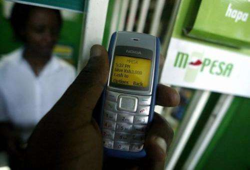 A man sends money through a mobile phone money service called M-PESA in Kenya's capital Nairobi on April 23, 2007