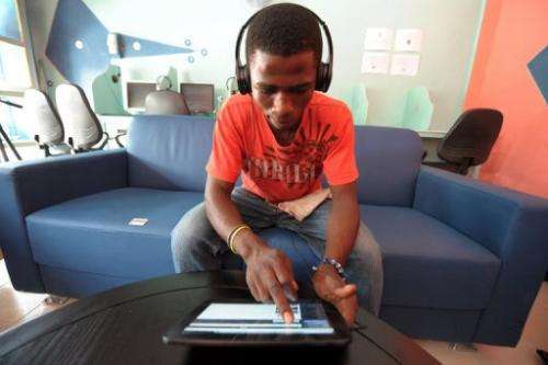 A man uses a tablet computer in the world's first tablet cafe, in Dakar, on May 28, 2013