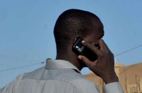 A man uses his telephone on a market place in Agadez, northern Niger, on September 26, 2010