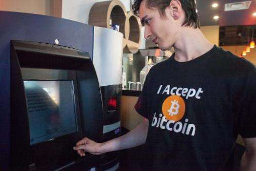 A man uses the world's first bitcoin ATM on October 29, 2013 at Waves Coffee House in Vancouver, British Columbia