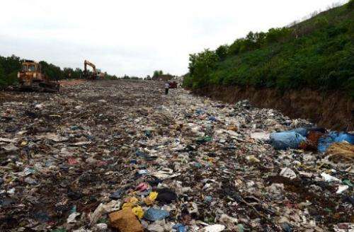 A man walks on a landfill site on the outskirts of Polish capital Warsaw on May 24, 2013