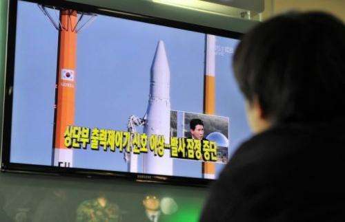 A man watches at a railway station in Seoul on November 29, 2012 live footage of an attempt to put a satellite in orbit