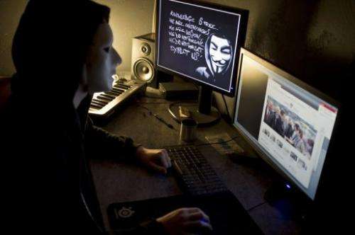 A masked hacker, part of the Anonymous group, hacks the French presidential Elysee Palace website on January 20, 2012